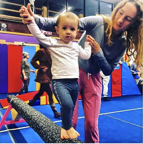 child being instructed at united gymnastics school in geauga county