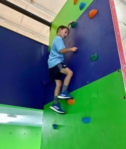 boy climbing warp wall