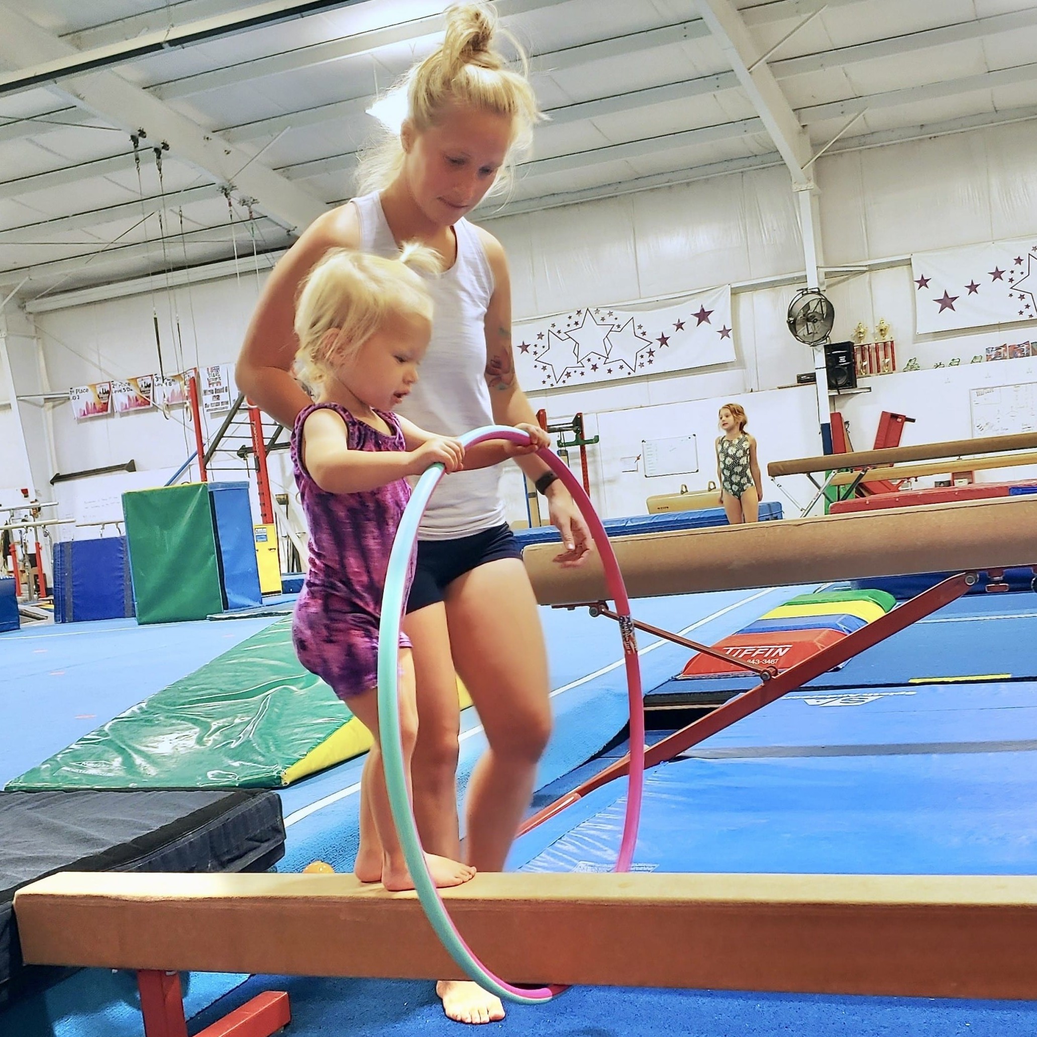mom and daughter in toddler gymnastics on balance beam