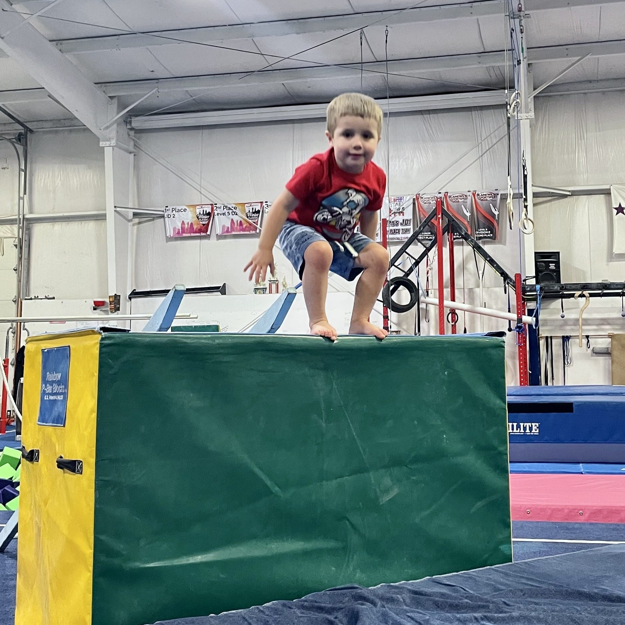 Toddler boy ready to jump off block in gymnastics